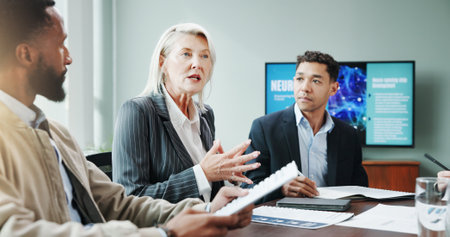 Meeting, business and people explaining in office for planning, neuroscience and innovation ideas. Manager, presentation and briefing with paperwork, brain technology and proposal with neurofeedbackの写真素材