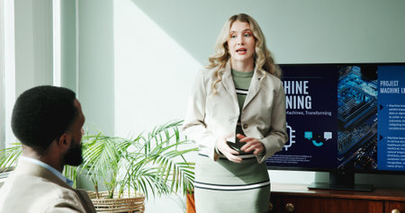 Business woman, monitor and presentation in office for new innovation, idea and ai product promotion. Speaker, talk and pitch proposal to team for equity funding, machine learning and tech workshopの写真素材