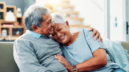 Smile, hug and senior couple in home, relax and commitment for relationship, bonding and love in lounge. House, old man and care for woman in living room, embrace and retirement for elderly peopleの写真素材