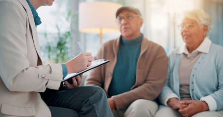 Therapy, psychologist and writing with old couple on sofa for support, marriage counseling and...