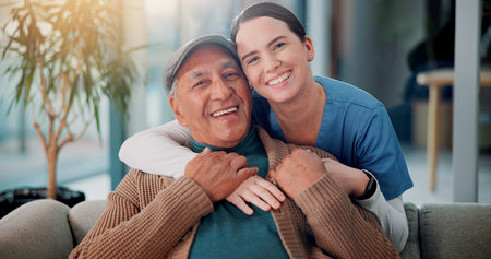 Portrait, nurse and hug old man in home for support, community care and geriatric wellness. Senior patient, happy caregiver and embrace for medical healthcare, assisted living and retirement togetherの写真素材