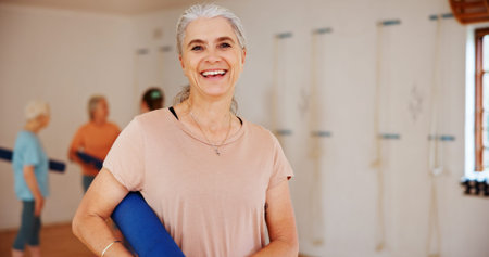 Senior, happy woman or portrait with yoga mat for pilates class, spiritual wellness or mental health. Face, female person or elderly yogi with smile for mindfulness, zen or holistic session in studioの写真素材