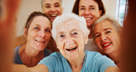 Selfie, senior and smile with woman group in home together for bonding, reunion or visit. Photograph, profile picture and social media with old people friends in retirement apartment for memoriesの写真素材