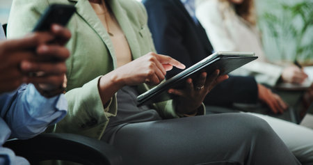 Hands, waiting room or businessman with tablet in queue for hiring registration, application or human resources. Resume, mobile or line for recruitment, employment vacancy or job search opportunityの写真素材