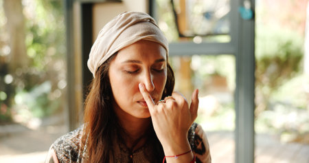 Alternate, nostril and woman with breathing meditation for calm mindset, relax and inner peace with zen. Nose, exhale and person in class for mindfulness, mental wellness and holistic self careの写真素材
