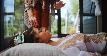 Spiritual, floor and woman with shaman, hands and ritual for self awareness, meditation and calm. Inner peace, chakra and zen with ceremony for soul, holistic and awakening of person with mantraの写真素材