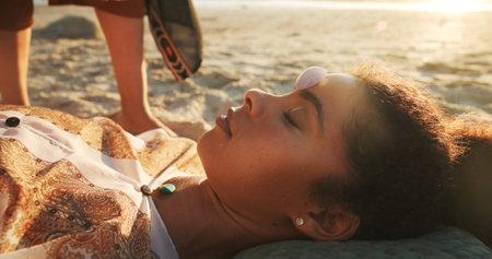 Woman, crystal and stone at beach with chakra balance, energy and therapy with rest on vacation. Person, rocks and holistic care with mineral, mindfulness and peace with zen on ground in summerの写真素材