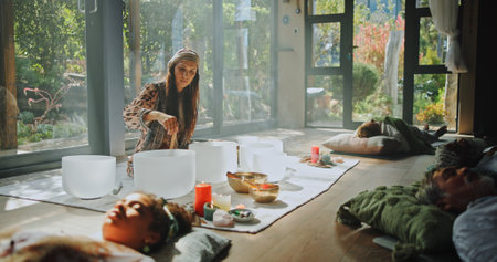 Woman, sound therapy and healing people with naturopath, homeopath ritual and holistic practice. Healer, bowl and aromatherapy for natural recovery, meditation and spiritual ceremony for mindfulnessの写真素材