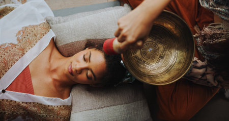 Healer, woman and healing with singing bowl, hands and vibration for inner peace with mantra and above. Meditation, sage and sound therapy with instrument for awakening, chant and holistic for personの写真素材