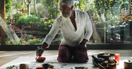 Healing, wellness and holistic with black man and incense for spiritual retreat, self care ritual and burning herbs. Aromatherapy, mindfulness and smudge ceremony with person for aura cleanseの写真素材