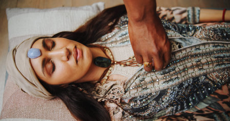 Crystal, meditation and zen with woman on floor for energy balance, healing ritual and spirituality. Third eye chakra, peace and holistic healer with person for aura cleanse and wellness ceremonyの写真素材