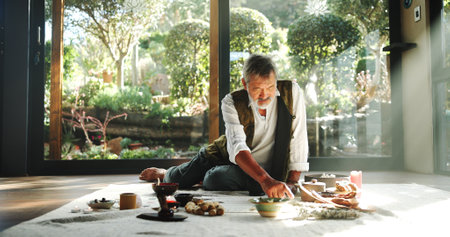 Incense, alternative medicine and Asian man on floor for spiritual meditation, holistic treatment and healing. Aromatherapy, cleanse and healer with stones for peace, chakra and detox for wellnessの写真素材