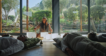 Woman, singing bowl and floor for holistic therapy, frequency and peace with mindfulness at studio....