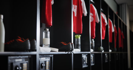 Empty, soccer equipment or locker room with gear for sport, fitness or training center. Row, line or aisle with clothing, water bottle or safe for fitting facility, interior or fashion of sportswearの写真素材