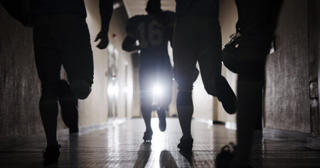 Group, football and running and team in corridor for sports competition, stadium match and game....