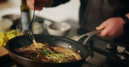 Hands, cooking and chef with pot, meal and preparation for dinner in kitchen, cuisine and restaurant. Catering, employee and person with food for supper, hospitality and skills for gourmet in dinerの写真素材