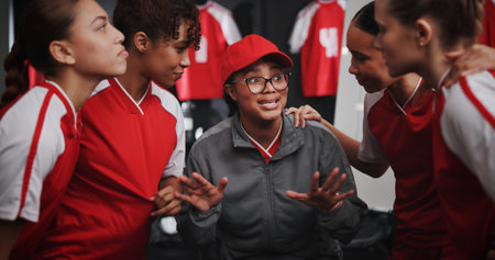 Women, coach and discussion with soccer team for motivation or collaboration in locker room. Female people, coordinator or talking with group or sport players in huddle for idea, game plan or matchの写真素材