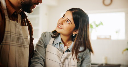 Conversation, cooking and couple in kitchen in home together for bonding, talking and connection, Happy, helping and man with woman for preparing meal, food or dinner for health diet in apartment.の写真素材