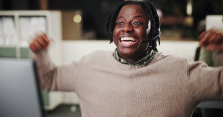Success, computer or excited black man in customer service for bonus prize, online solution or good news. Achievement, wow or happy African agent in night with smile, call center win or sales goalの写真素材