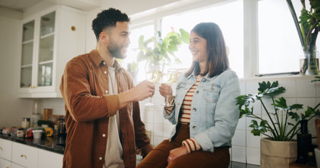 Kitchen, couple and glasses of wine for cheers, celebration and anniversary in healthy relationship. Home, man and woman with alcohol drink for toast, commitment and bonding with love in marriageの写真素材