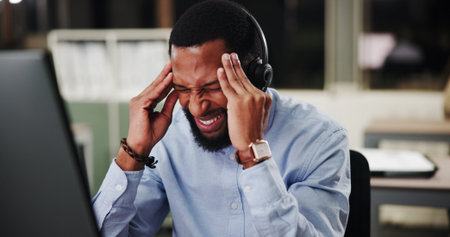 Black man, call center and computer with stress at night, headache or pain with communication or...
