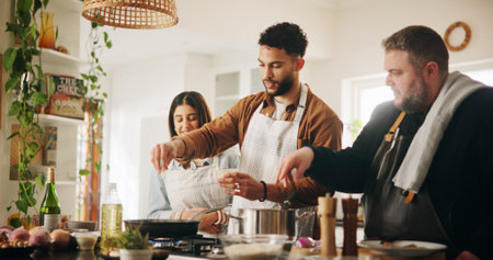 Cooking class, chef and couple with learning in kitchen for meal preparation, culinary skills and recipe instructions. Professional guide, people and food lesson with dinner tips and nutrition adviceの写真素材