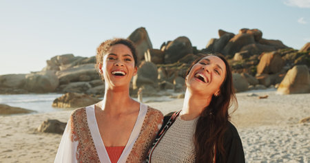 Women, friends and happy on beach for travel, reunion and hug for support in relationship. People, laugh and excited at ocean for shared memories, funny story and summer vacation on Brazil seasideの写真素材