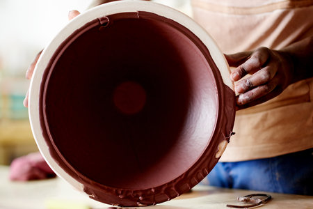 Pottery, ceramics and hands of person in studio for artisan, sculpture and handicraft talent. Entrepreneur, project and manufacturing with closeup of artist in workshop for small business and hobbyの写真素材