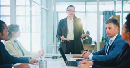 Investor, feedback or business people with speech in presentation for funding, review or investment. Woman speaker, group or manager with proposal ideas for project meeting, budget or risk managementの写真素材