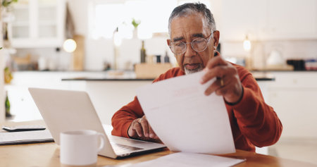 Senior man, documents and taxes with stress in home, reading and financial review for pension....