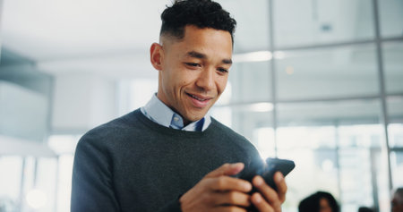 Business man, phone and happy at meeting, texting and scroll with low angle for deal at company....