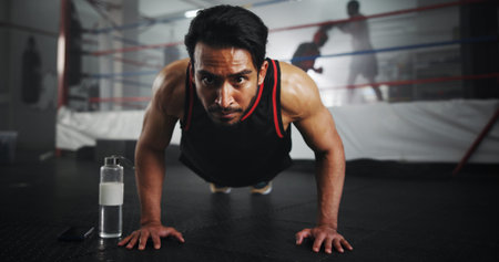 Man, push ups and boxer in gym for fitness, warm up or ready for training for match, strength and...
