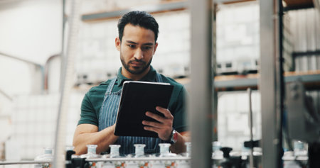 Distillery, tablet and man in factory for checklist for alcohol production, manufacturing or...