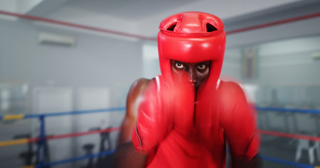 Boxing, training and man at gym for exercise, intense fight or combat skills with sports motion blur. Self defense, action or energy with portrait of serious boxer, challenge and practice for matchの写真素材