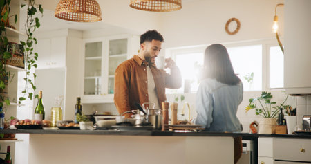 Home, kitchen and couple with coffee to drink, cooking and anniversary for relationship in morning. House, man and woman with beverage for love, commitment and bonding with meal perp in marriageの写真素材