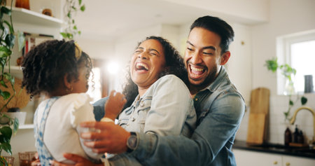 Laughter, happy family and parents play with girl in kitchen together and excited for tickle game. Child, mother and father with energy bonding with kid, love and care for weekend break in homeの写真素材