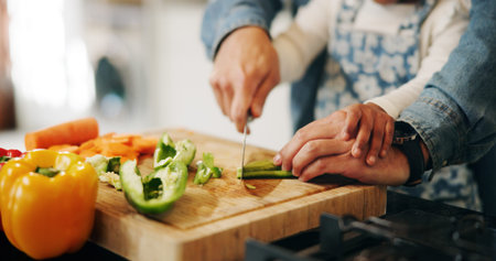 Hands, parent and child with vegetables to chop, cooking and bonding with learning skills at home....