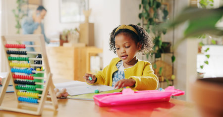 Home, studying and child with notebook, education and learning for elementary with abacus and information. Apartment, student and girl with homework, growth and development of kid with knowledgeの写真素材