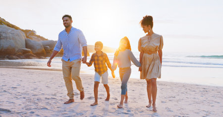 Parents, walk and holding hands with kids on beach for summer holiday, travel and bonding together. Family, children and journey on ocean for getaway, tropical vacation and adventure of weekend tripの写真素材