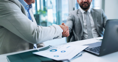 Business men, deal and shaking hands in office for merger, partnership or acquisition. Finance, team and handshake for collaboration with company buyer for share purchase, joint venture or agreementの写真素材