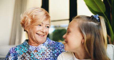 Bonding, family or love with grandmother and grandchild on sofa in living room of retirement home...