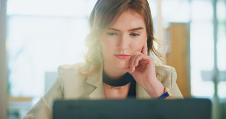 Thinking, corporate and woman on laptop in office for planning, research and budget review at company. Female person, thoughts and online for financial report, feedback ideas and negotiation proposalの写真素材