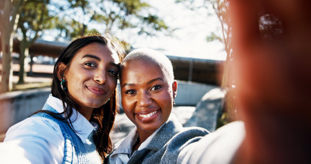 Happy women, portrait and city with selfie for photography, picture or outdoor post at park. Face, female people or friends with smile for capture moment, social media or memory together in townの写真素材
