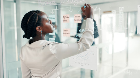 Black woman, writing or schedule planning with glass board at office for brainstorming ideas. Female...