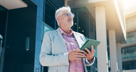 Mature, businessman and realtor with tablet in city for corporate real estate, property or vision. Man, CEO or building investor with technology or thinking for business development in an urban townの写真素材