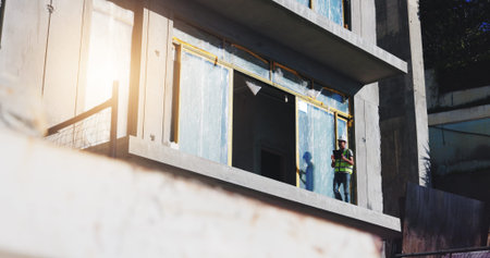 Construction site, engineer and man with tablet, city and inspection in low angle, architecture and...