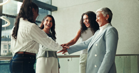 Business women, team building and stack hands for collaboration, motivation and laugh in office. Happy group, huddle and support with workers for corporate mission, goal and synergy for cooperationの写真素材