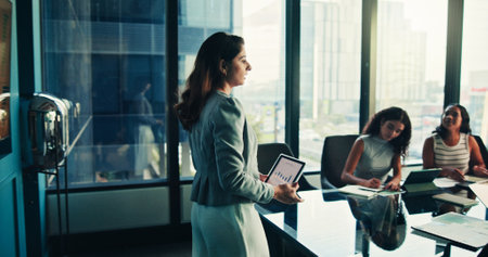 Boardroom, presentation and woman with tablet, group and data analyst with info, graphs and online. Meeting, colleagues and presenter with tech for insights, screen and people with digital reportの写真素材