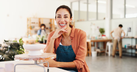 Woman, portrait and smile at pottery workshop with pride for career with sculpture, artist and job at studio. Person, happy and talent for craft with design, product and creativity at ceramic storeの写真素材