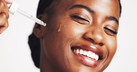 Skincare, serum and woman with product, smile and moisturizing of face with liquid, hydration and...